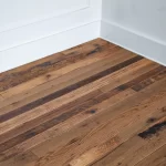 A room with wood floors and a white wall