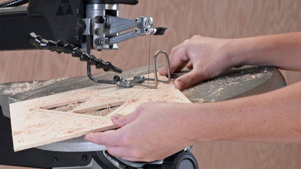a man using a scroll saw