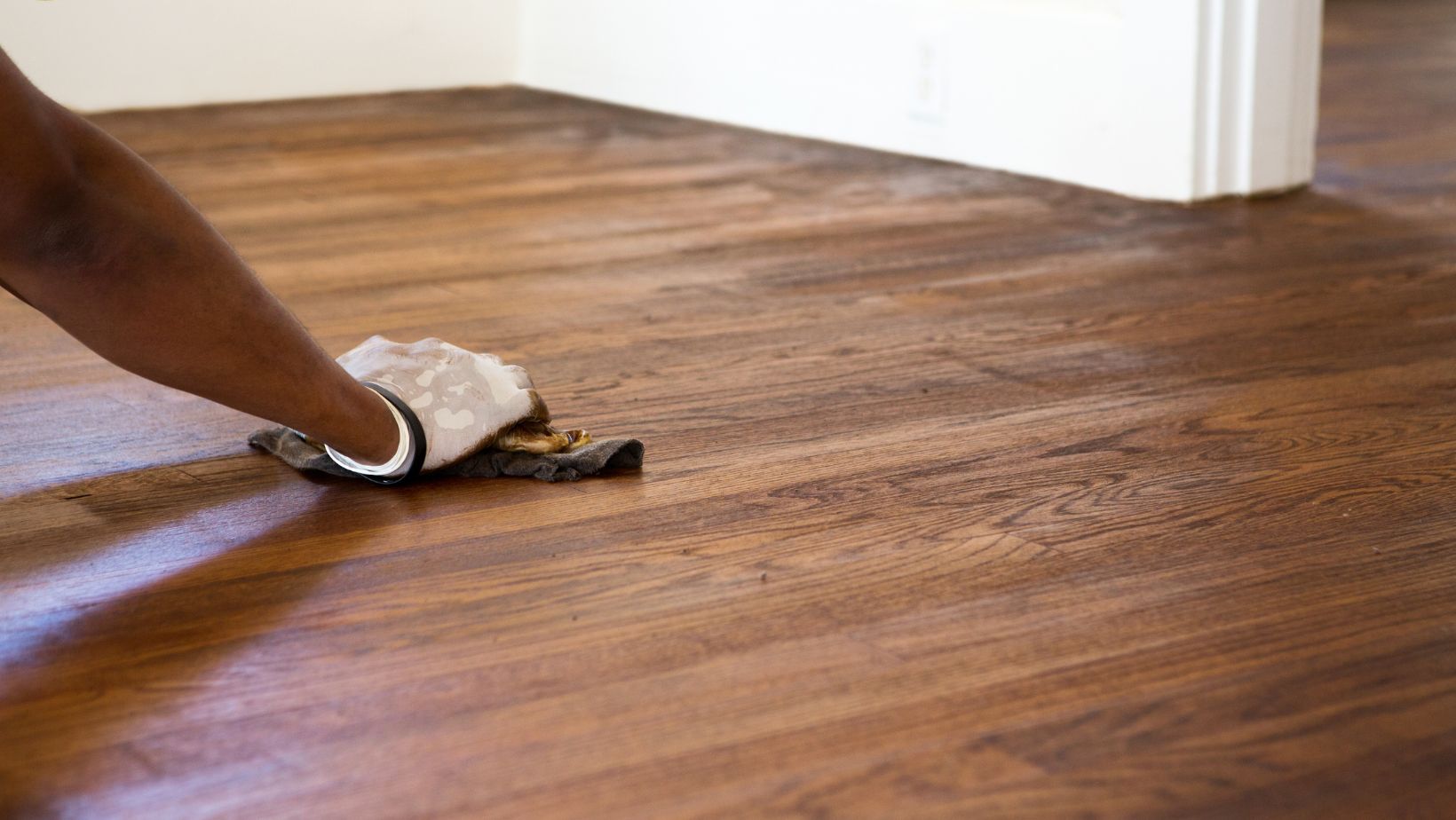 A person swiping wood flooring