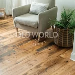 Industrial Oak engineered hardwood flooring paired with a cozy gray lounge chair and woven basket planter in a bright living space.
