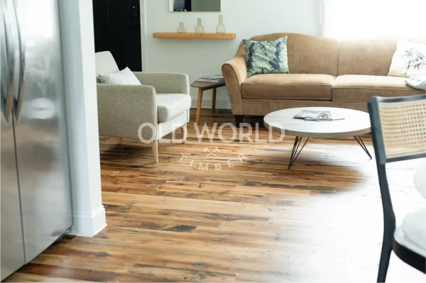 Open living room with Industrial Oak flooring, neutral furniture, and natural light highlighting the reclaimed wood’s patina.
