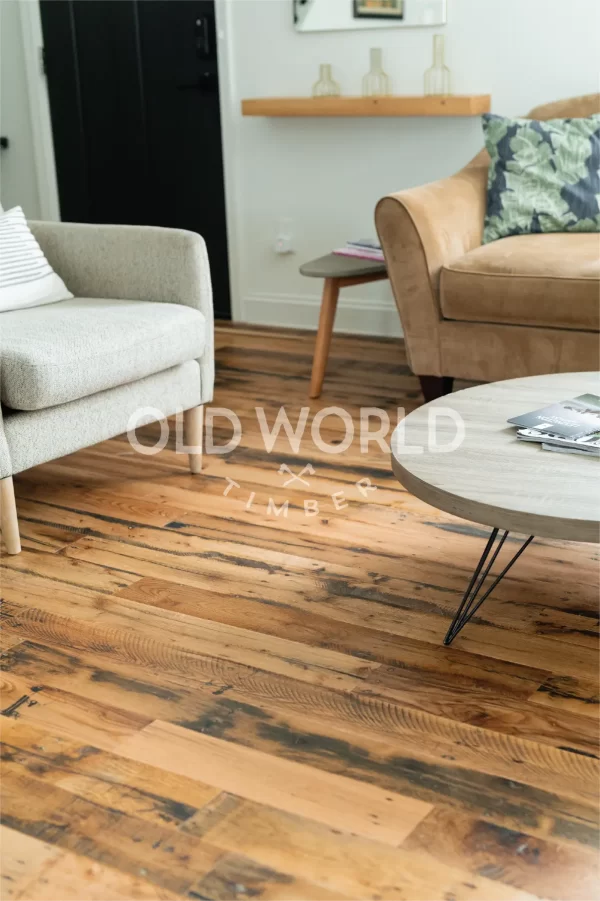 Industrial Oak engineered wood flooring in a modern living room with neutral decor and reclaimed textures visible on each plank.