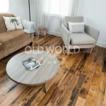 Industrial Oak engineered floors featuring nail holes and aged grain beneath clean, modern furniture in a well-lit space.