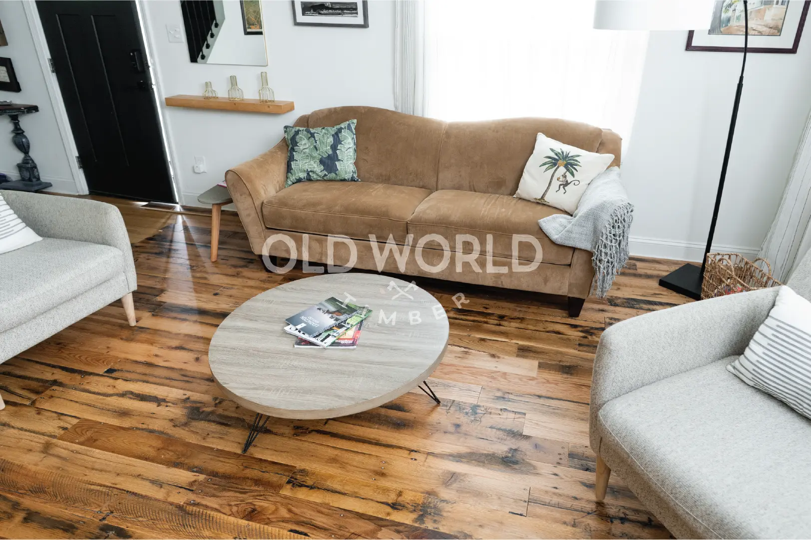 Full room view of engineered reclaimed oak floors with a rustic-modern blend of furniture, showcasing warmth and industrial charm.