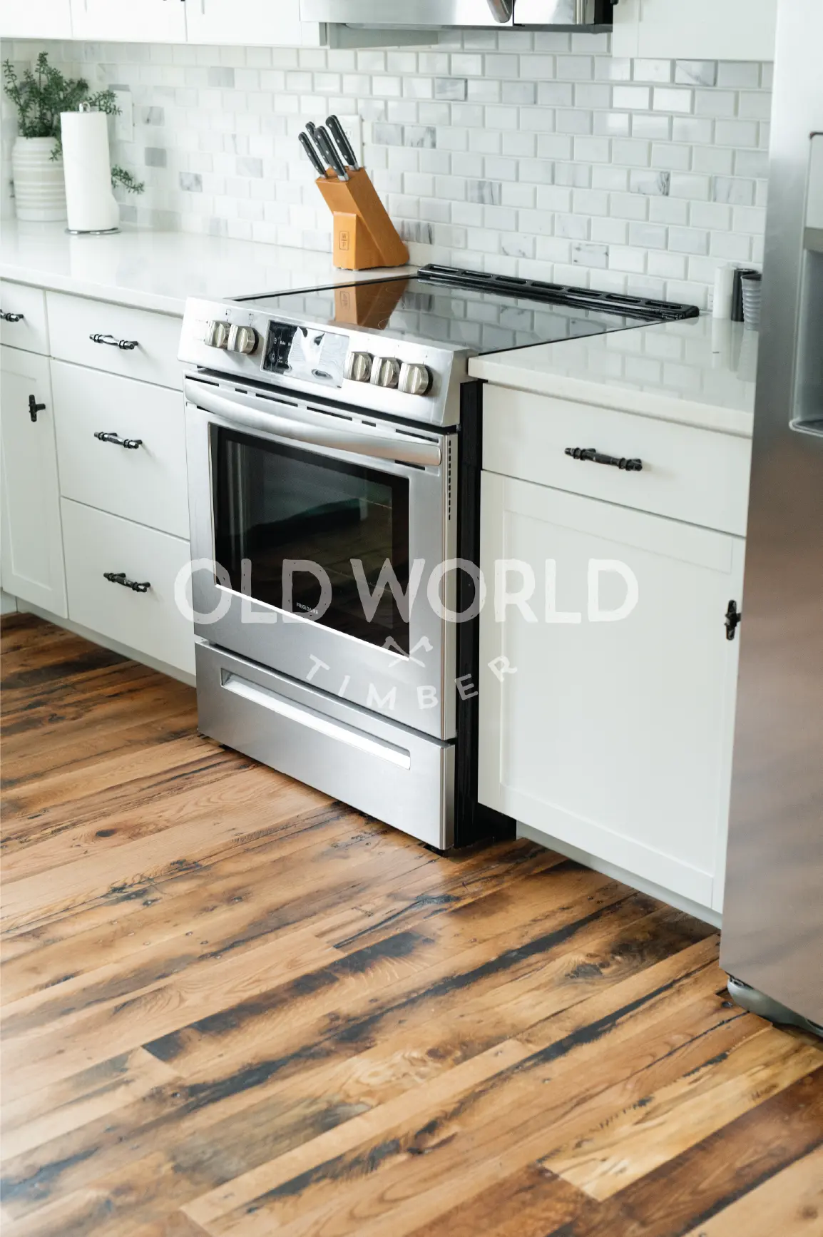 Reclaimed Industrial Oak flooring showcasing dark grain patterns and historic nail holes in a contemporary kitchen setting.