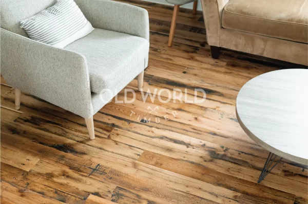 Reclaimed Industrial Oak flooring adding warmth and texture to a cozy living room with neutral-toned furniture.