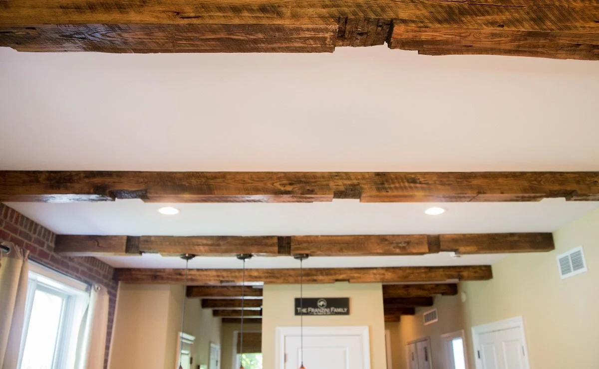 a white ceiling with rustic reclaimed box beams and white recessed lights for sale