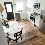 Top corner kitchen view featuring Heartland Barnwood Mixed Oak engineered reclaimed flooring with natural variation and rustic tones.