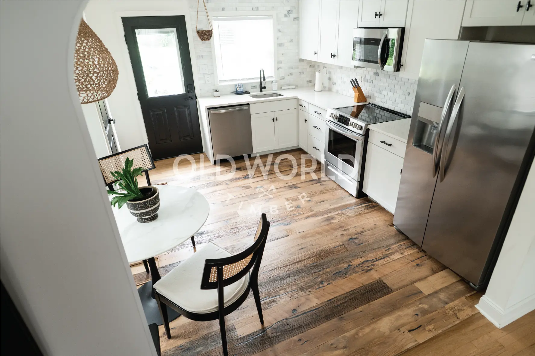 Top corner kitchen view featuring Heartland Barnwood Mixed Oak engineered reclaimed flooring with natural variation and rustic tones.