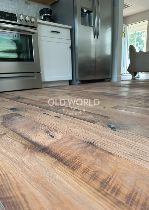 Low angle view of Heartland Barnwood Mixed Oak engineered reclaimed wood flooring highlighting natural saw marks and character in a kitchen setting.