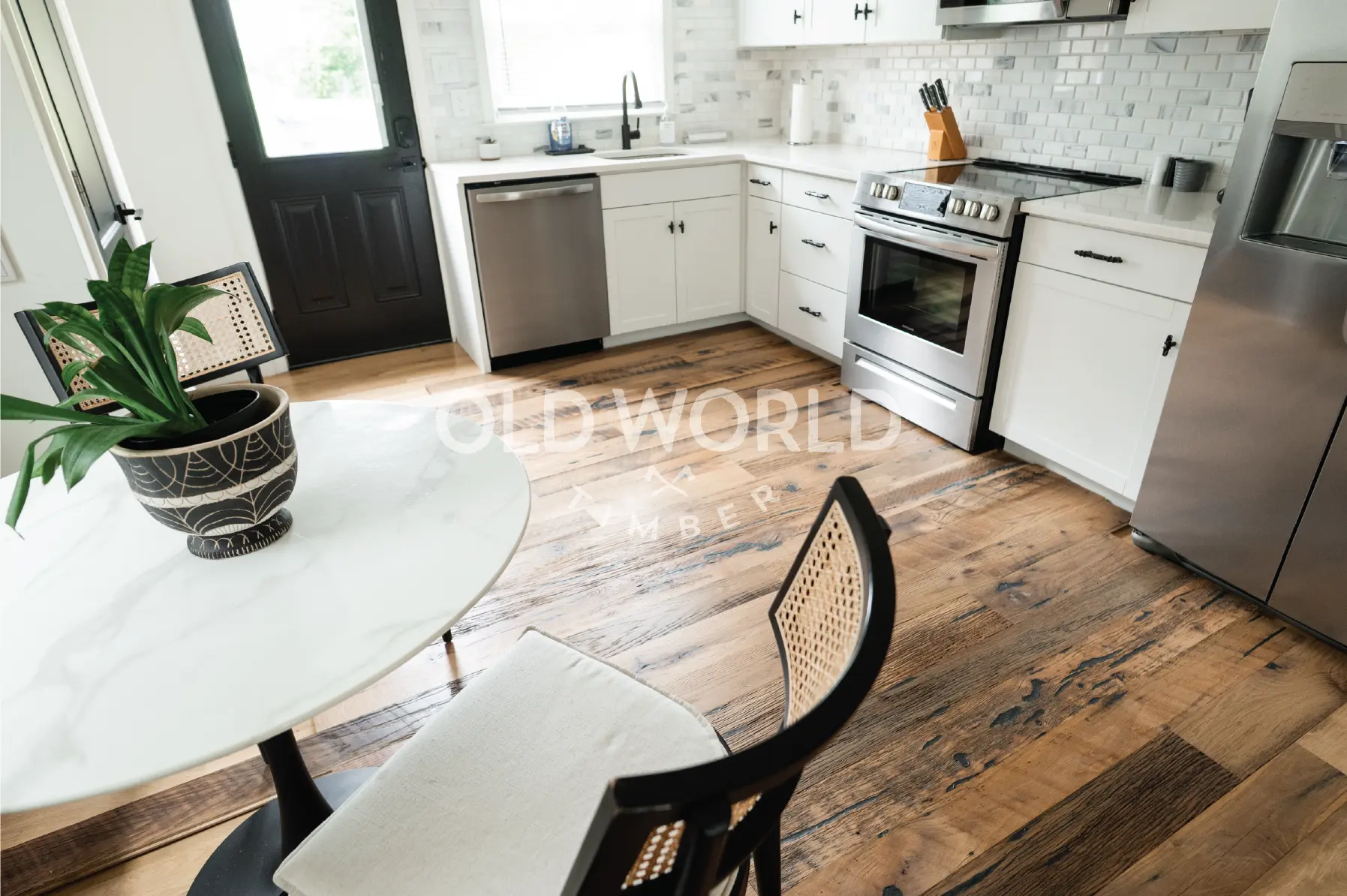 Bright modern farmhouse kitchen with natural light showcasing Heartland Barnwood Mixed Oak engineered reclaimed flooring with rustic charm.