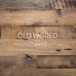Flat lay view of reclaimed Heartland Barnwood Mixed Oak engineered flooring, featuring knots, dark patina, and historic saw marks.