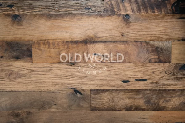 Flat lay view of reclaimed Heartland Barnwood Mixed Oak engineered flooring, featuring knots, dark patina, and historic saw marks.