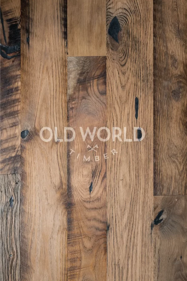 Vertical close-up view of Heartland Barnwood Mixed Oak engineered reclaimed flooring highlighting wood grain, knots, and nail holes.