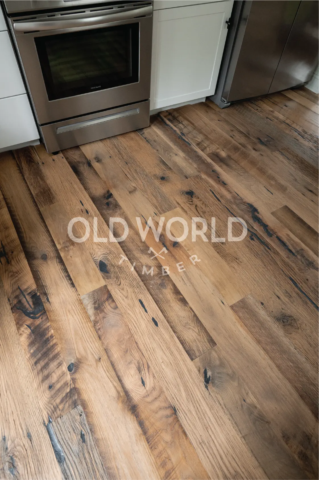 Kitchen floor angle with Old World Timber’s Heartland Barnwood engineered planks featuring reclaimed patina, nail holes, and warmth.