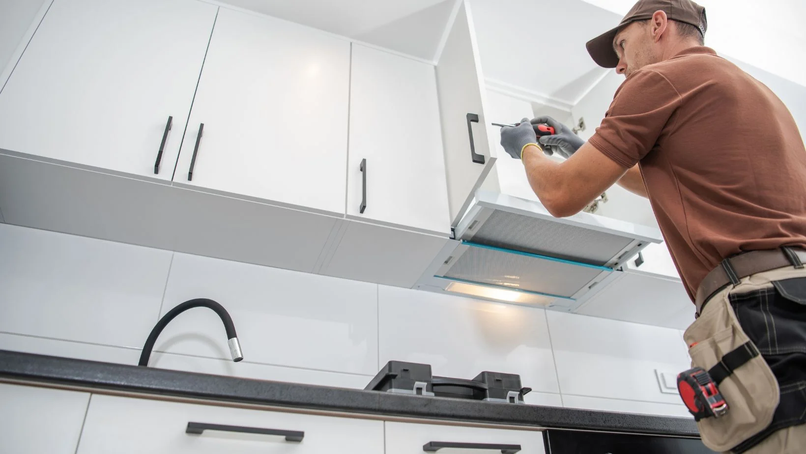 man installing cabinets