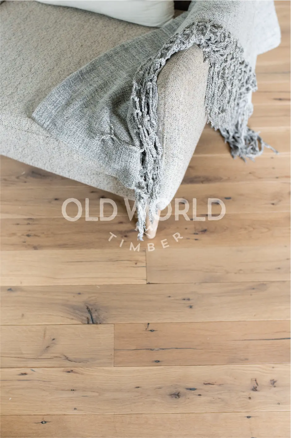 Natural reclaimed white oak engineered flooring showing clean face surface with subtle marks of age and use.