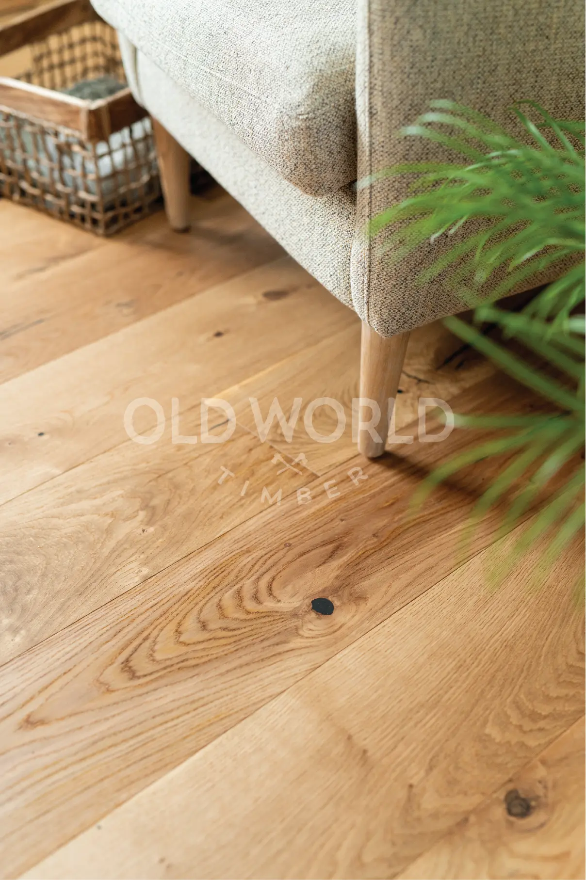 Modern Harvest engineered oak floor beneath a textured armchair, showing the natural variation and smooth matte finish.