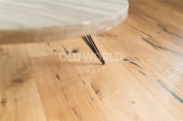 Close-up of Modern Harvest Engineered Oak Flooring showcasing natural grain and character beneath a round modern coffee table.
