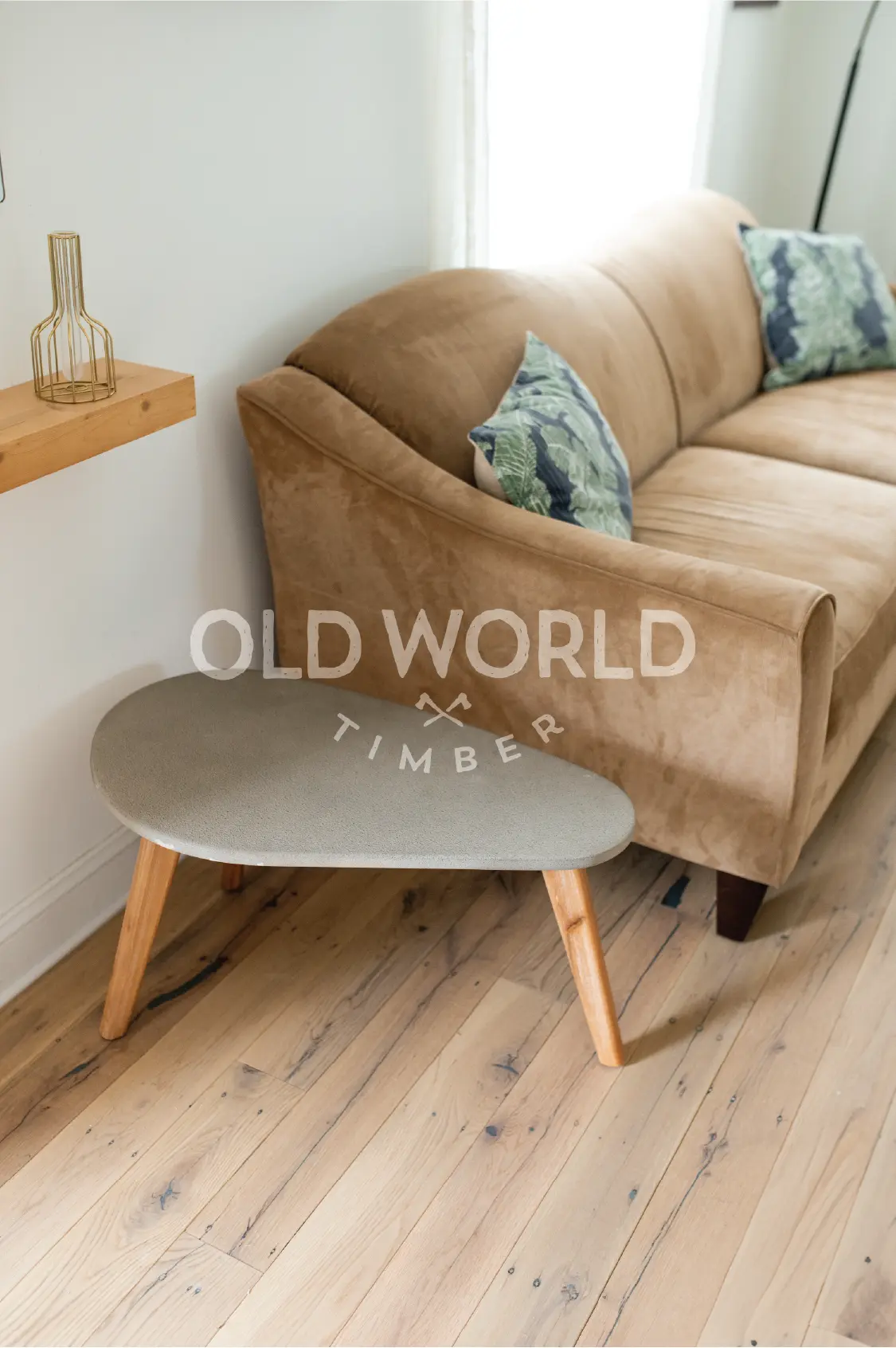 Detailed image of reclaimed white oak flooring beneath a textured gray throw, showing the natural beauty and imperfections of antique hardwood.