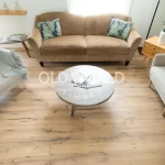 Overhead view of engineered oak flooring reclaimed from antique factories, highlighting natural wood grain patterns in a modern lounge space.