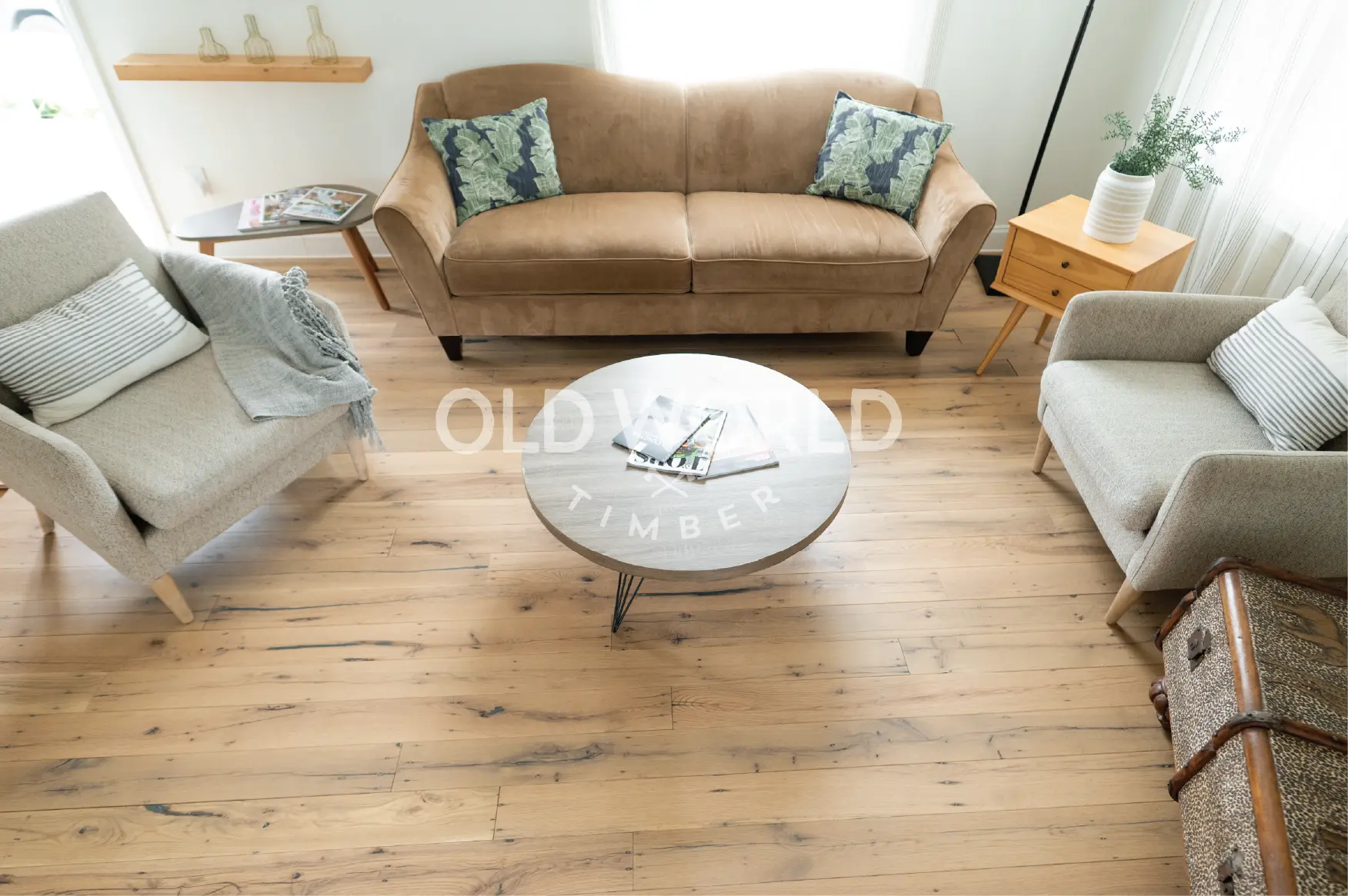Overhead view of engineered oak flooring reclaimed from antique factories, highlighting natural wood grain patterns in a modern lounge space.