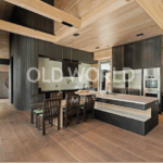 Rift and quartered oak engineered flooring in a modern kitchen and dining space with architectural lighting and exposed beams.