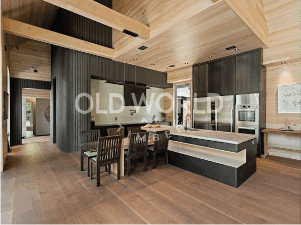 Rift and quartered oak engineered flooring in a modern kitchen and dining space with architectural lighting and exposed beams.