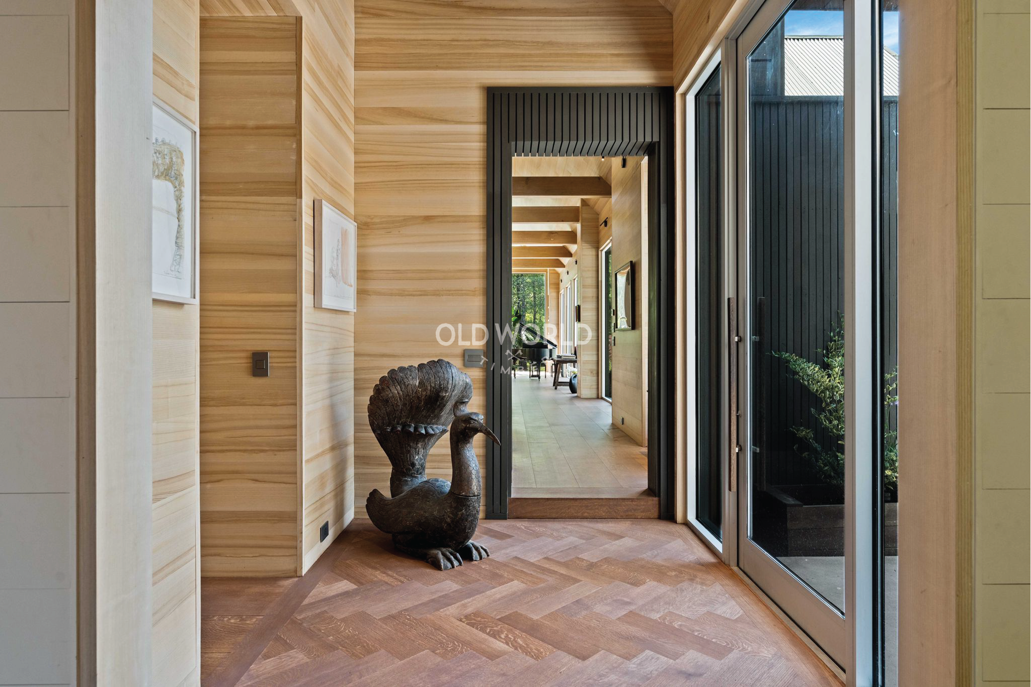 Contemporary home entry with Oak Rift and Quartered flooring and vertical wood paneling.