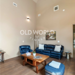Wide-plank Oak Rift and Quartered engineered flooring in a contemporary living room with high ceilings and modern seating.