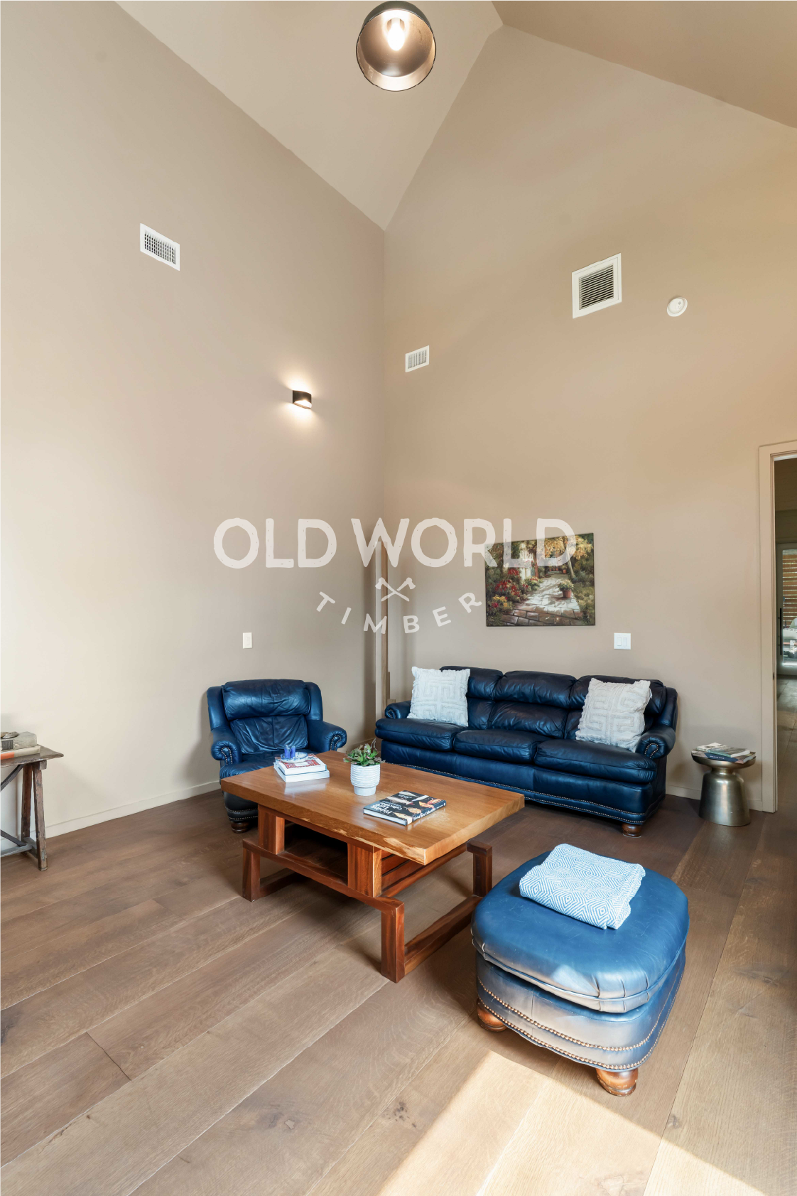 Wide-plank Oak Rift and Quartered engineered flooring in a contemporary living room with high ceilings and modern seating.